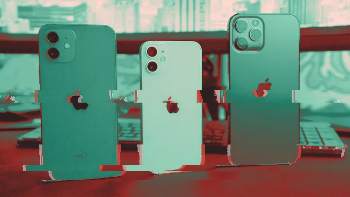 Backs of red, white and blue iPhones with Apple logos standing on a desk